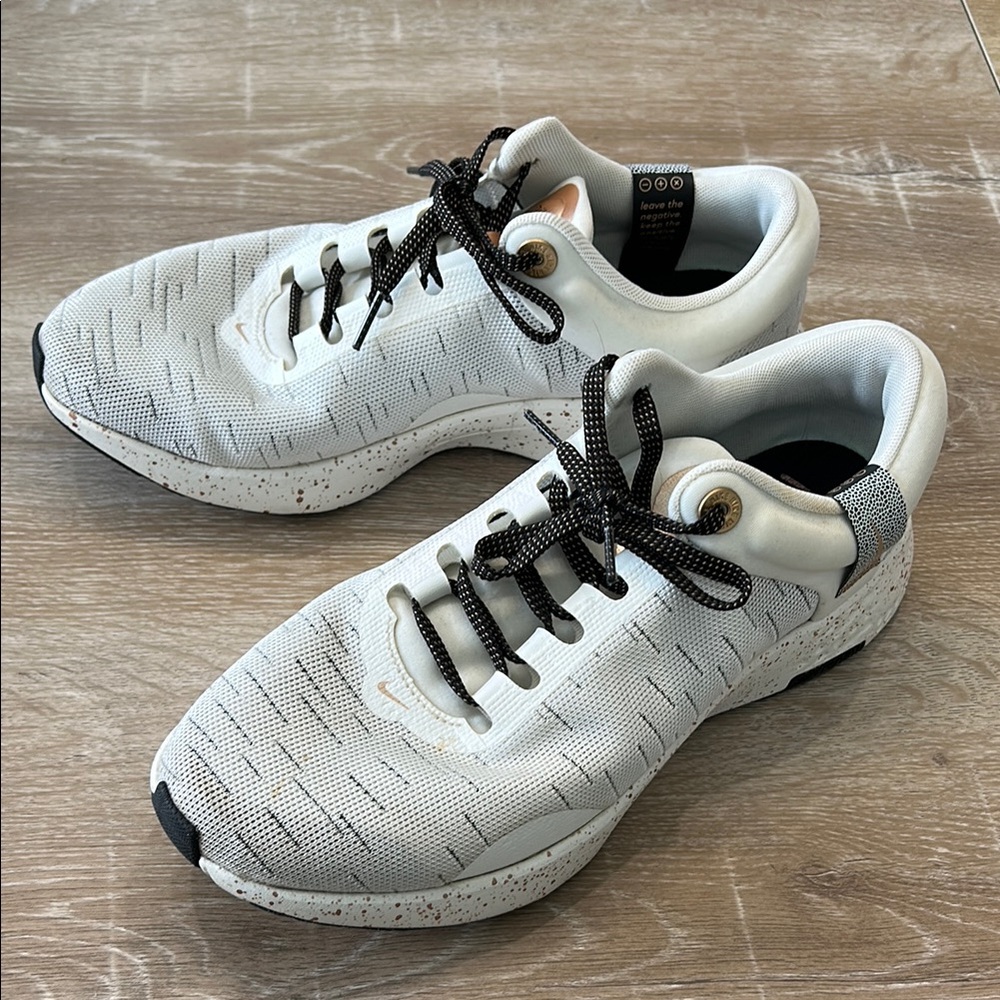 White Nike Shoes with black and gold accents